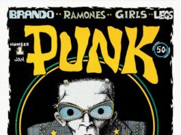 Cover der ersten Ausgabe des PUNK Magazins von Januar 1976, gestaltet von John Holmstrom. Illustration zeigt Lou Reed in Comicstil mit übergroßer Brille und Lederjacke.